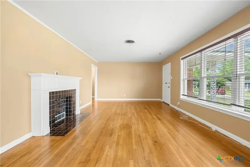 Living room facing the fireplace and entry
